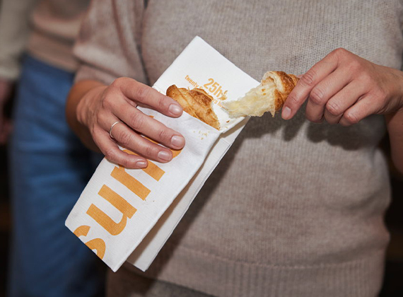 Woman holding branded linen feel napkin pocket
