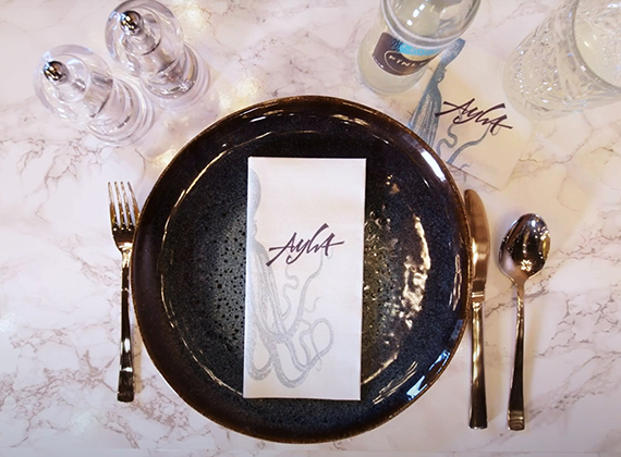 White pre-folded branded napkin on restaurant table