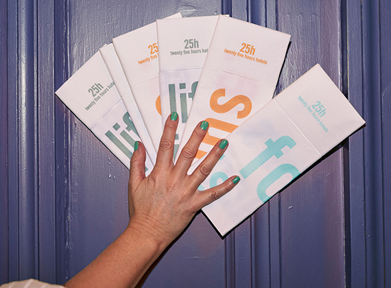 Woman holding range of customised linen feel napkin pockets