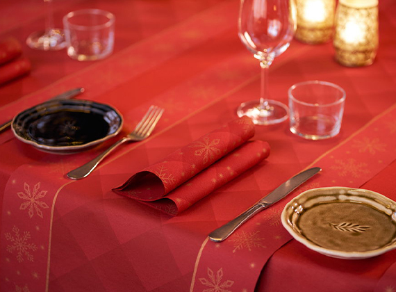 Red festive design paper napkin on matching table runner