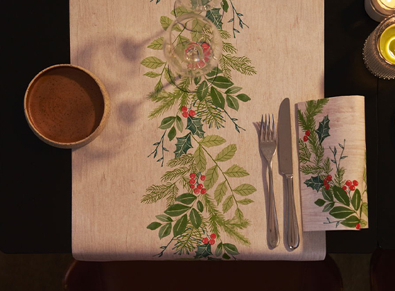 Aerial view of restaurant place setting with festive winter greenery