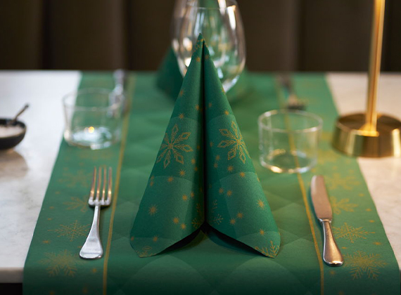 Festive green napkin and table runner place setting