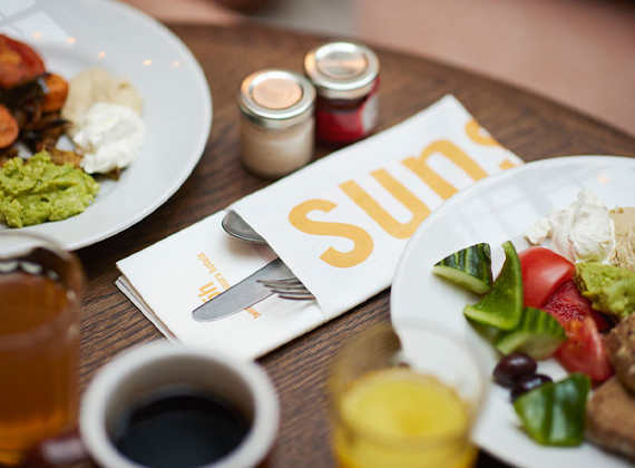 Branded napkin pocket with cutlery on restaurant table